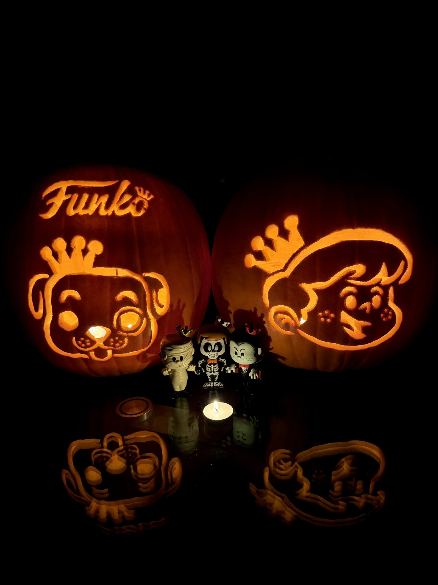 Marissa Gilbraith @FunkoHuntersPNW, winning pumpkins, Freddy Funko and Proto, carved. Halloween SODAs in front.